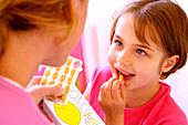 Young girl taking food supplement