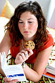 Teenage girl eating a cookie