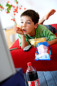 Child snacking and watching TV