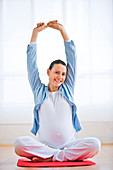 Pregnant woman stretching arms