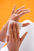 Woman applying gauze compress