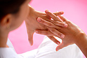 Woman massaging her hands