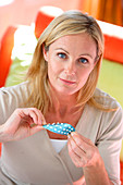 Woman holding contraceptive pills