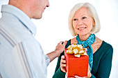 Elderly woman receiving a present