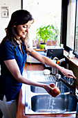 Woman washing fruit