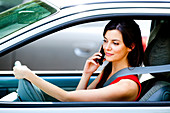 Woman using cell phone while driving