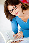 Woman with glasses reading a book