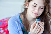 Woman smelling essential oil