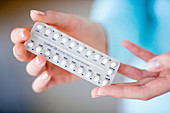 Woman with contraceptive pills