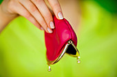 Woman holding an empty moneybox