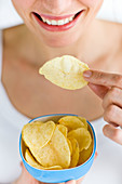 Woman eating potato chips