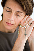 Senior woman holding rosary