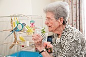 Care home resident and pet bird
