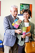 Senior couple reading brochure