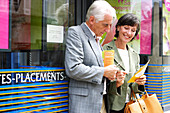 Senior couple reading brochure