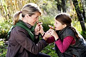 Mother and child picking mushrooms