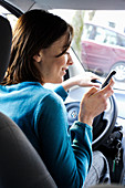 Woman using cell phone when driving