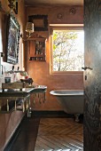View through open door into vintage bathroom with historical ambiance