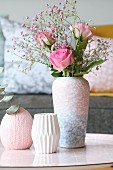 Roses and pink gypsophila in mottled vase