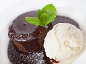 Chocolate souffle served with chocolate sauce and ice cream