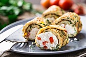 Omelette rolls with curd and herbs on a plate