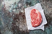 Raw fresh marbled meat Black Angus Steak Ribeye on metal background
