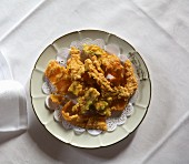 Vegetable tempura on a vintage plate (seen from above)