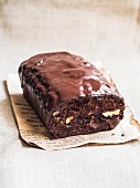 Loaf of gluten-free chocolate cake made with green banana flour, dates and nuts