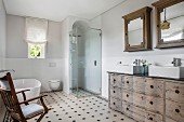 Washstand made from old chest of drawers and patterned tiles in bathroom