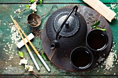 Chinese Tea Set and chopsticks on rustic wooden table