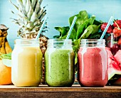 Freshly blended fruit smoothies of various colors and tastes in glass jars