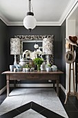 Lavishly decorated table in foyer with dark walls