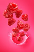 Raspberries falling into raspberry juice