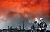 Oil and gas workers with red sky