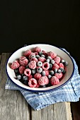 Frozen blueberries and raspberries in a bowl