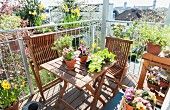 Wooden furniture and spring flowers on balcony