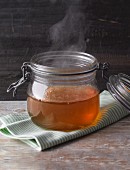 Steaming stock in a glass storage jar