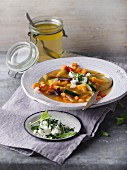 Oriental vegetable soup with herb and feta topping