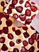 Close-up of a raspberry tray bake cake (seen from above)