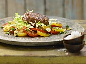 Steak tartare with a tomato and olive salad