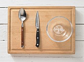 Kitchen utensils: spoon, kitchen knife, glass bowl