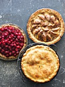 Three Assorted Fruit Pies with Slices Removed