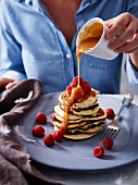 Cream cheese pancakes with butterscotch sauce and fresh raspberries