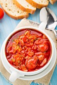 Vegetable soup made of cherry tomatoes, carrot, potato, cabbage in a bowl