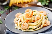 Tagliatelle with shrimps and parsley on a plate