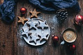 Almonds cinnamon Christmas cookies on a plate and rustic wooden table