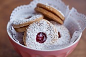 Spitzbuben (jam cookies) with a doiley in a small bowl