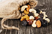 Nuts and dried fruits on wooden background