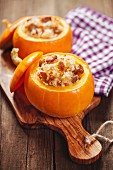 Roasted little pumpkins stuffed with chicken meat, vegetables and rice