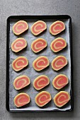 Pink pinwheel cookies dough before baking on a pan